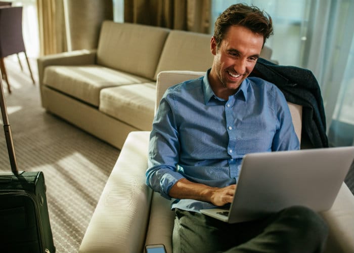 Man works on laptop in hotel