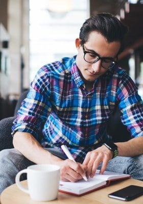 Male writer working in cafe